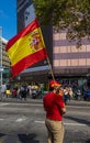 Anonymous person dressed in red with a flag of Spain against the independence of Catalonia