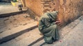 Anonymous poor beggar in the street of Fez, Morocco.