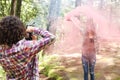 Anonymous profesional Photographer taking photographs of model in the forest holding a red smoke bomb at Costa Rica Royalty Free Stock Photo