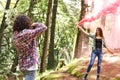 Anonymous profesional Photographer taking photographs of model in the forest holding a red smoke bomb at Costa Rica Royalty Free Stock Photo