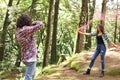 Anonymous profesional Photographer taking photographs of model in the forest holding a red smoke bomb at Costa Rica Royalty Free Stock Photo