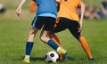 Anonymous Soccer Players Compete in a Duel on Sunny Day. Football Game For Children. Soccer Background of Young Players