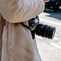 Anonymous Woman Carrying A Fujifilm Digital Camera With Lens