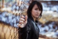 Anonymous woman portrait over fence