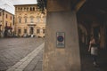 Anonymous woman walking in pathway in old town