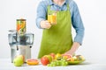 Anonymous woman wearing an apron, offering glass of freshly pressed juice, healthy lifestyle concept Royalty Free Stock Photo