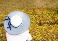 Anonymous women wearing blue hats sit alone. Royalty Free Stock Photo