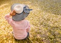 Anonymous women wearing blue hats sit alone. Royalty Free Stock Photo