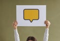 Woman holding paper card with yellow blank mockup speech balloon or message icon