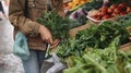 An Anonymous Young Woman Deliberates Over Lush Organic Vegetables and Greens, Embracing the Essence of Farmers Market Shopping Royalty Free Stock Photo