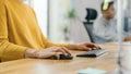 Anonymous Young Woman Sitting at Her Desk Using Laptop Computer. Focus on Hands Using Mouse and Ke Royalty Free Stock Photo