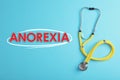 Anorexia concept. Stethoscope on light blue background, top view