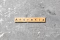 Anorexia word written on wood block. anorexia text on table, concept