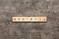 anorexia word written on wood block. anorexia text on table, concept