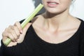 Anorexic girl eating a leek