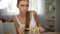 Anorexic girl measuring glass of water with tape, exhausted body, obsession