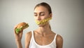 Anorexic girl ties mouth with tape, fights with temptation to eat burger