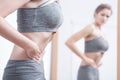 Anorexic woman watching herself in a mirror Royalty Free Stock Photo