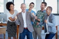 Another business success story. a group of happy coworkers celebrating standing in an office. Royalty Free Stock Photo