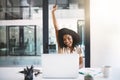 Another day, another success. a happy young businesswoman celebrating at her desk in a modern office. Royalty Free Stock Photo