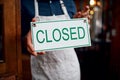 Another day of hard work done. Closeup of a unrecognizable business owner holding up a sign saying closed while standing Royalty Free Stock Photo