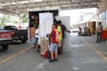 Another employee helps home owner load supplies