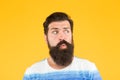 Another idea. Have some doubts. Hipster bearded face not sure. Doubtful bearded man on yellow background close up
