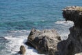 Another rock resisting the waves of the sea Royalty Free Stock Photo