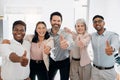 Another successful day in the bag. a diverse group of businesspeople standing in the office and showing a thumbs up. Royalty Free Stock Photo