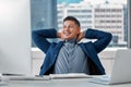 Another successful day in the office. a handsome young businessman sitting alone in the office with his hands behind his Royalty Free Stock Photo