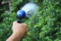 View from the back of a woman holding a tree sprinkler Royalty Free Stock Photo