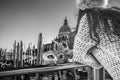 Closeup on Venetian mask in hand of woman in Venice, Italy