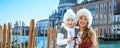 Mother and daughter travellers viewing photos on camera, Venice