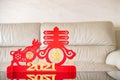 anox mascot and symbol of spring as symbol of Chinese New Year of the Ox in front of a sofa the Chinese means spring and good luck Royalty Free Stock Photo