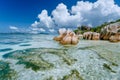 Anse Source d`Argent in low tide - Paradise tropical beach with shallow blue lagoon, granite boulders and white clouds Royalty Free Stock Photo