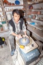 a potter demonstrates pottery making with a turn table and pottery clay