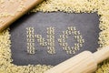 The answer no made up of a set of words yes, with small pasta letters on a dark background wooden board surrounded by other le Royalty Free Stock Photo
