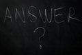 answer ? - the word answer handwritten with chalk on a blackboard with question mark