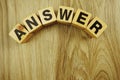 Answer word in wooden cube alphabet letters top view on wooden background