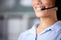 Always answering calls with a smile. an unrecognisable call centre agent wearing a headset in the office during the day. Royalty Free Stock Photo