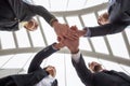 business team gather hands in city