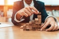 Ant eye view Male hand stacking wooden blocks. Business development and growth concept Royalty Free Stock Photo