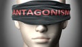 Antagonism can make things harder to see or makes us blind to the reality - pictured as word Antagonism on a blindfold to