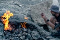 Tourist photographs natural small fires on Mount Chimaera Yanartas, Turkey