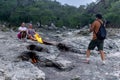 Tourists take pictures in the background of natural small fires on Mount Chimaera Yanartas, Turkey