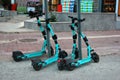 Antalya, Turkey - April 9, 2022: BinBin electric scooters are parked at the sidewalk. Popular urban transportation, available for