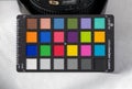 Antalya, Turkey - April 3, 2023: Calibrite Colorchecker Classic Mini color calibration card standing on wooden blocks on blue