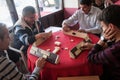 Local turkish men playing very table game Okey, or rummikub, in