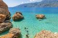 Tourists are swimming by enjoying the turquoise waters in Suluada of Adrasan. Antalya-Turkey Royalty Free Stock Photo