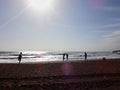 Antalya, Turkey - December 26, 2019: View from sand beach to water of sea, waves, pier and black silhouette of person in a nice